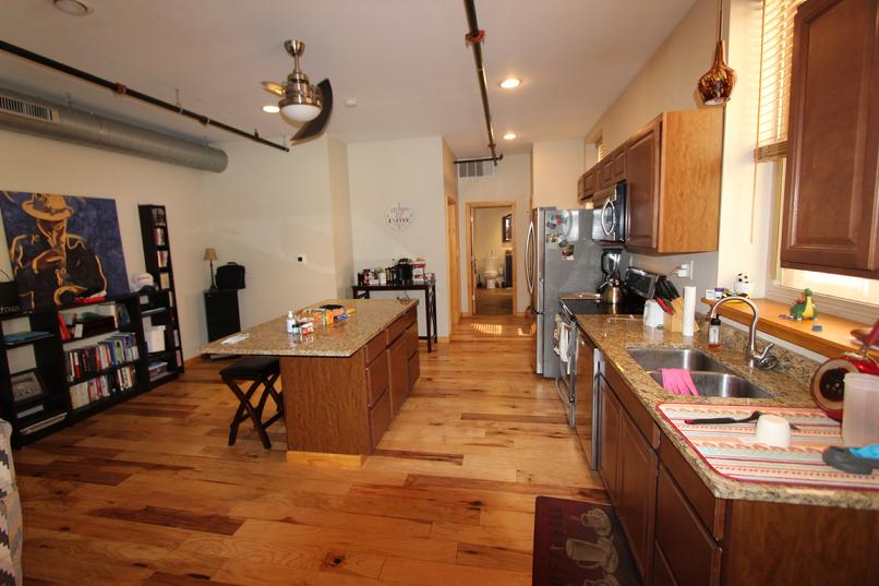 Open kitchen with wooden floors